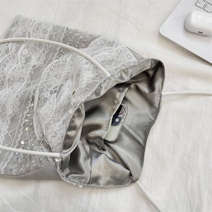 Macro shot showing the spacious inner pocket of this silver lace tote bag with sequins