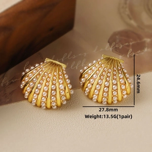 Detail view of shell-shaped pearl earrings with gold base and dimensions 27.8mm x 24.6mm