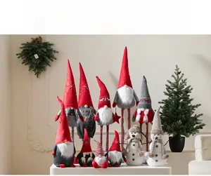 Detailed view of Christmas gnomes and snowmen plush toys in red and grey festive colors