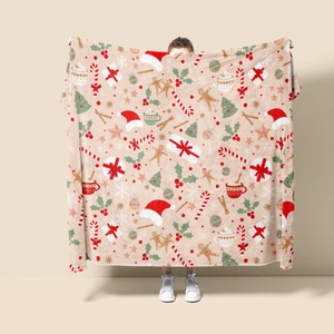 Detail of Christmas flannel blanket with festive gingerbread man and tree pattern