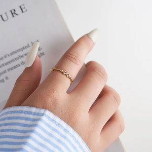 Elegant gold bow-shaped S925 sterling silver open ring worn on a finger