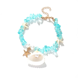 Blue gravel beaded beach bracelet with white seashell, starfish charms, and pearl detail