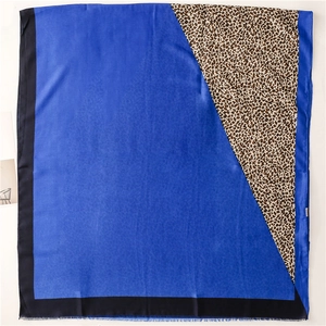 Close-up of royal blue scarf with bold leopard print patchwork and black borders