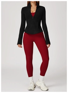 Close-up of black fleece jacket and burgundy yoga leggings for fitness training