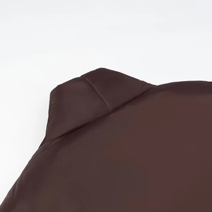 Close-up of a brown oversized padded jacket collar with a V-neck design and smooth finish