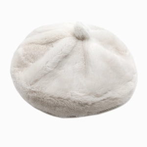 Close-up of white fluffy faux fur beret featuring soft plush texture and top pom-pom detail