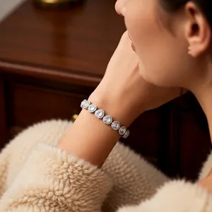 Elegant silver tennis bracelet with heart zircons worn by model in a cozy scene