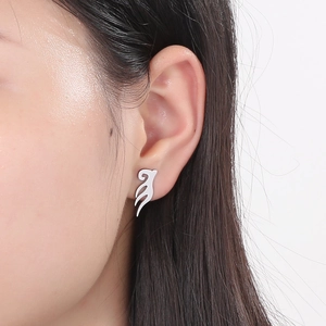 Macro shot of silver leaf earrings showing fit and leaf shape on a model