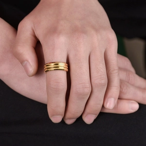 Frosted gold-plated stainless steel triple band ring for men and women on model's hand