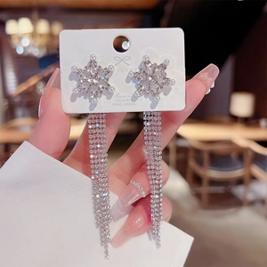 Detailed view of s925 silver needle snowflake tassel earrings with pavé rhinestones