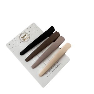 Set of 4 matte seamless hair clips in brown and neutral earth tones on display card