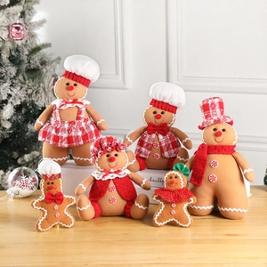 Christmas gingerbread man plush doll set with festive accessories on wood background