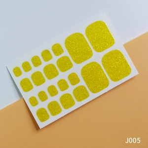 Golden glitter toe nail stickers set with shiny finish for pedicure on a bicolor background