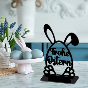 Detailed view of black acrylic Easter egg ornament with Frohe Ostern bunny cutout design