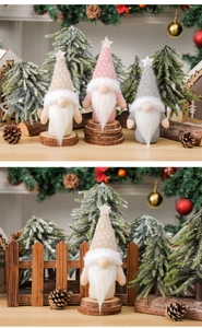 Close-up of three knitted Christmas gnomes with star hats and faux fur beards decor