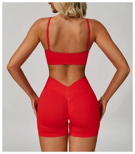 Rear view of seamless red sports bra and V-waist yoga shorts with ribbed texture
