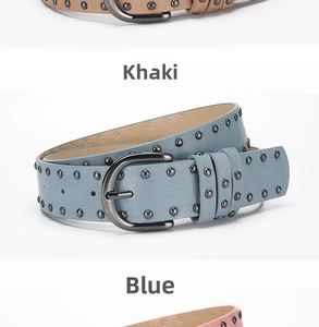Detail of punk style wide waist belts with round metal studs in khaki, blue and pink