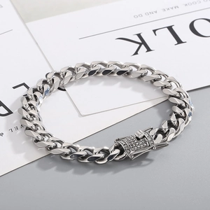 Detailed macro of polished silver Cuban link chain with luxury iced out pavé clasp