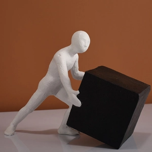 Modern minimalist resin human sculpture pushing a black cube for office and home decor