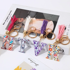 Fashionable alphabet keychains with colorful patterns and leather tassels for bags