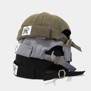Three minimalist canvas miki hats in army green, grey, and black with adjustable metal buckles