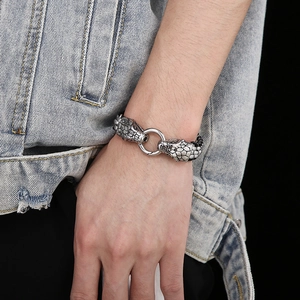 Men's stainless steel braided bracelet featuring a detailed double snake head clasp