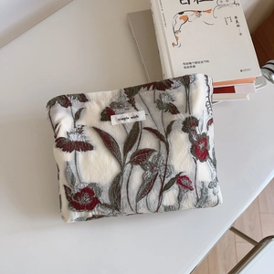 Detailed close-up of floral embroidery and 'simple wish' label on white canvas bag