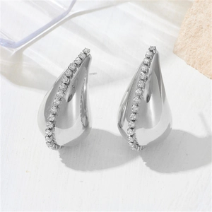 Silver hollow teardrop earrings with a single row of inlaid zircons on a white stone base