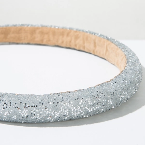 Close-up of sparkling silver glitter headband with premium soft inner lining texture
