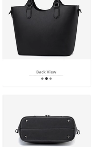 Detail view of large black tote bag back and bottom with silver metal protective studs