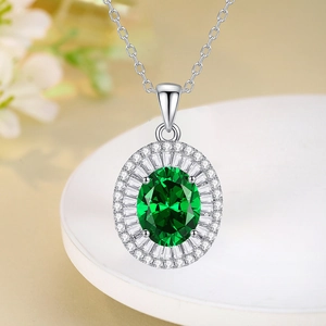 S925 silver necklace with emerald pendant and white diamonds on a white tray