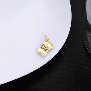 Macro detail of 18K gold-plated dollar sign pendant for customized jewelry making