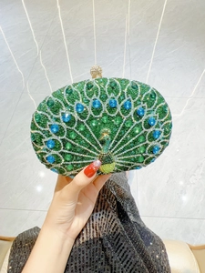 Detailed close-up of peacock-shaped evening clutch bag with green and blue sparkling rhinestones