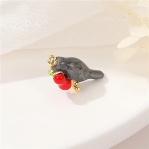 Detail of bird pendant with grey marble pattern, red gourd, and golden metal accents