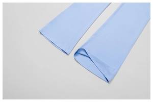 Close-up of double-stitched hem on light blue high-stretch yoga leggings with flat seams