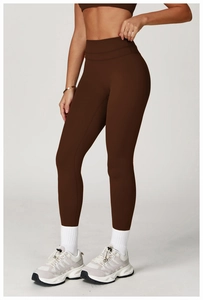 Detail view of high-waisted deep brown yoga leggings with a tight fit for fitness training