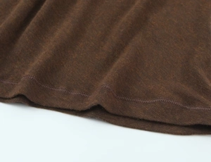 Detailed close-up showing the precise double-needle stitching on the brown knit fabric hem