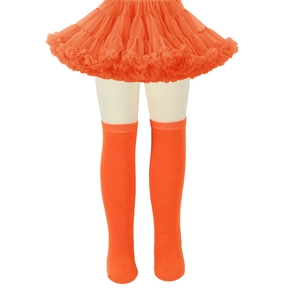 Detail of children striped knee-high socks and orange tutu skirt with mesh texture