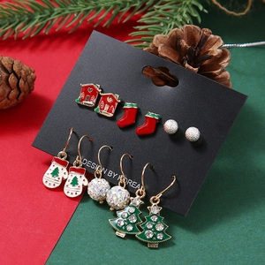 Close-up of a 6-pair Christmas earring set with reindeer, Santa, and festive bell designs