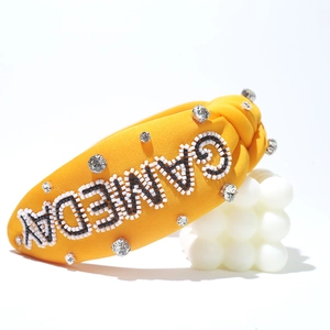 Yellow knotted headband with GAMEDAY beaded lettering and rhinestones for party wear