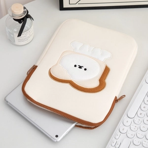 Detail view of cute toast embroidery on a padded 11-inch laptop sleeve and iPad pouch