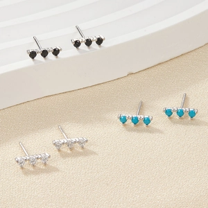 S925 silver bar stud earrings set with black blue and white zircons on display
