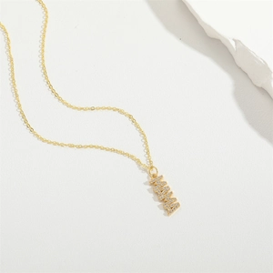 Elegant gold MAMA letter pendant necklace with clear gemstones on white background