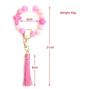 Pink silicone bead wristlet keychain with Jesus cross charm and faux leather tassel