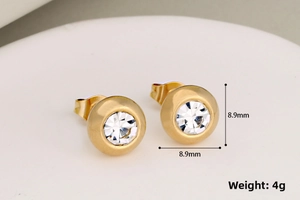 Detailed view of 8.9mm gold round stud earrings with sparkling round cubic zirconia