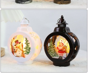 Close-up of lit Christmas lanterns with snowman and Santa patterns on a textured surface