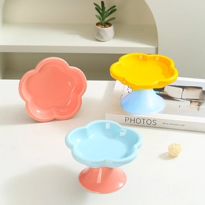 Creative flower-shaped ceramic cat bowls in pastel colors on a modern minimalist table