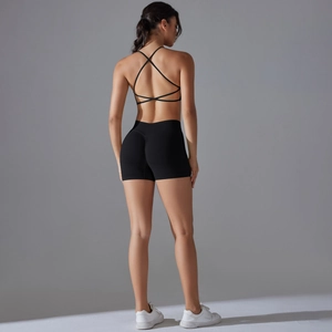 Detail of cross-back sports bra and scrunch butt gym shorts in black elastic fabric