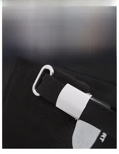 Detail of adjustable black baseball cap rear strap with a silver metal buckle closure