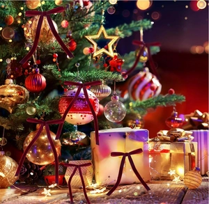 Macro detail of wine red velvet Christmas bow ornaments with elegant long ribbons on tree